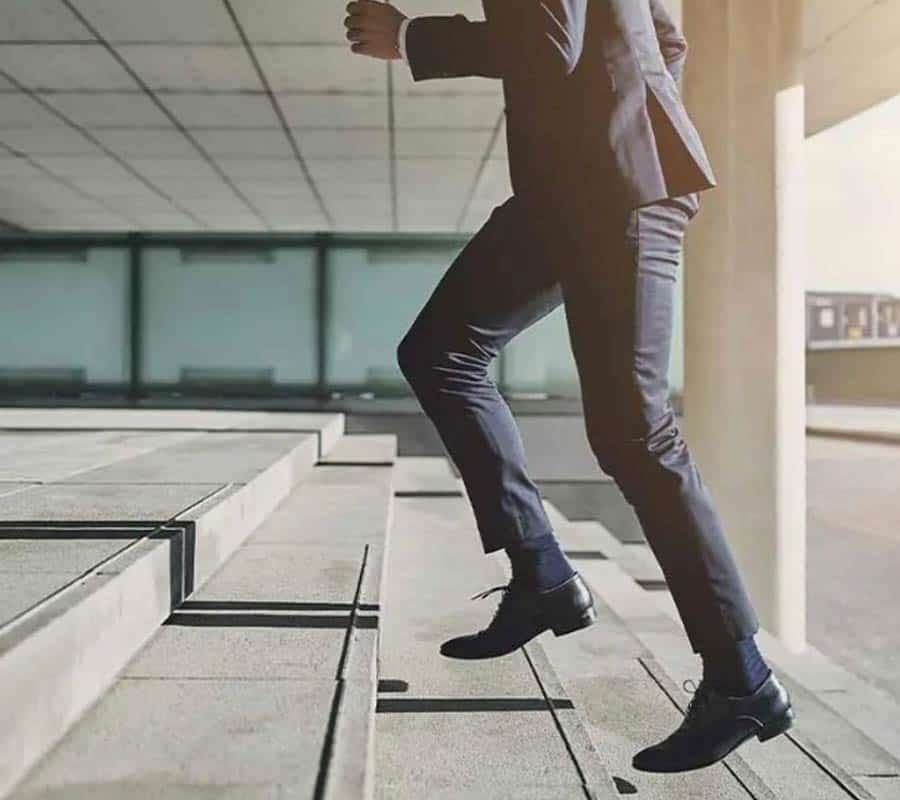 businessman climbing stairs